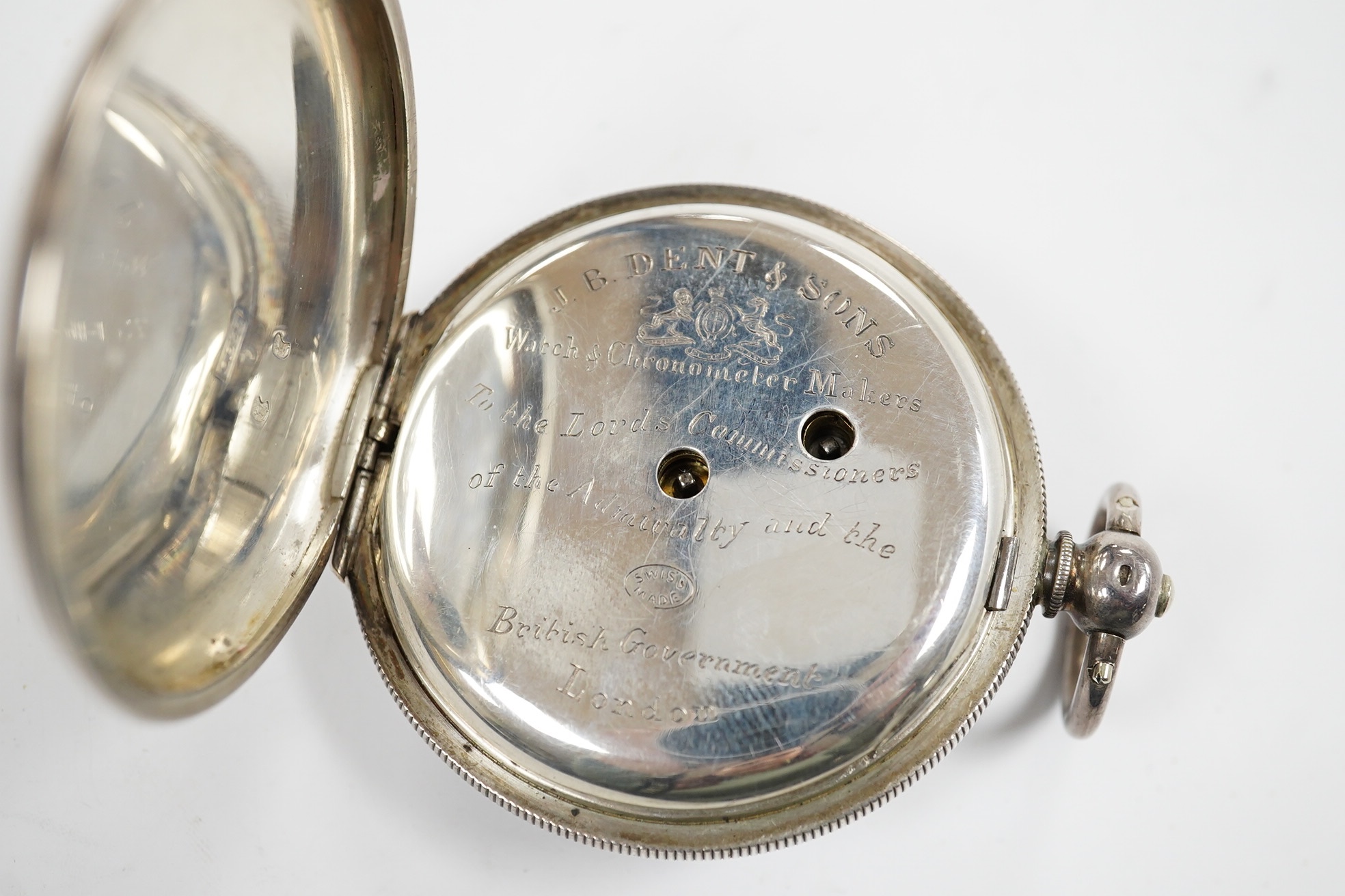 A late 19th century engine turned Swiss 935 standard white metal key wind open faced pocket watch, with engraved inscription relating to J.B. Dent & Sons, London, case diameter 53mm. Condition - fair